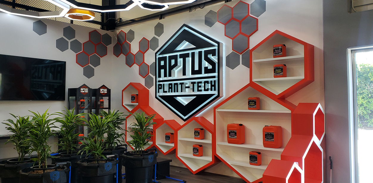 Aptus retail store interior design with modern black and red illuminated hexagonal displays