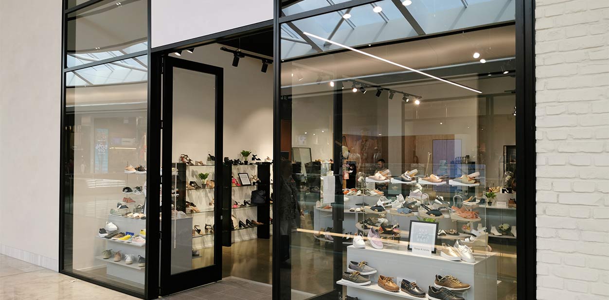 Modern retail storefront design with floor-to-ceiling glass doors