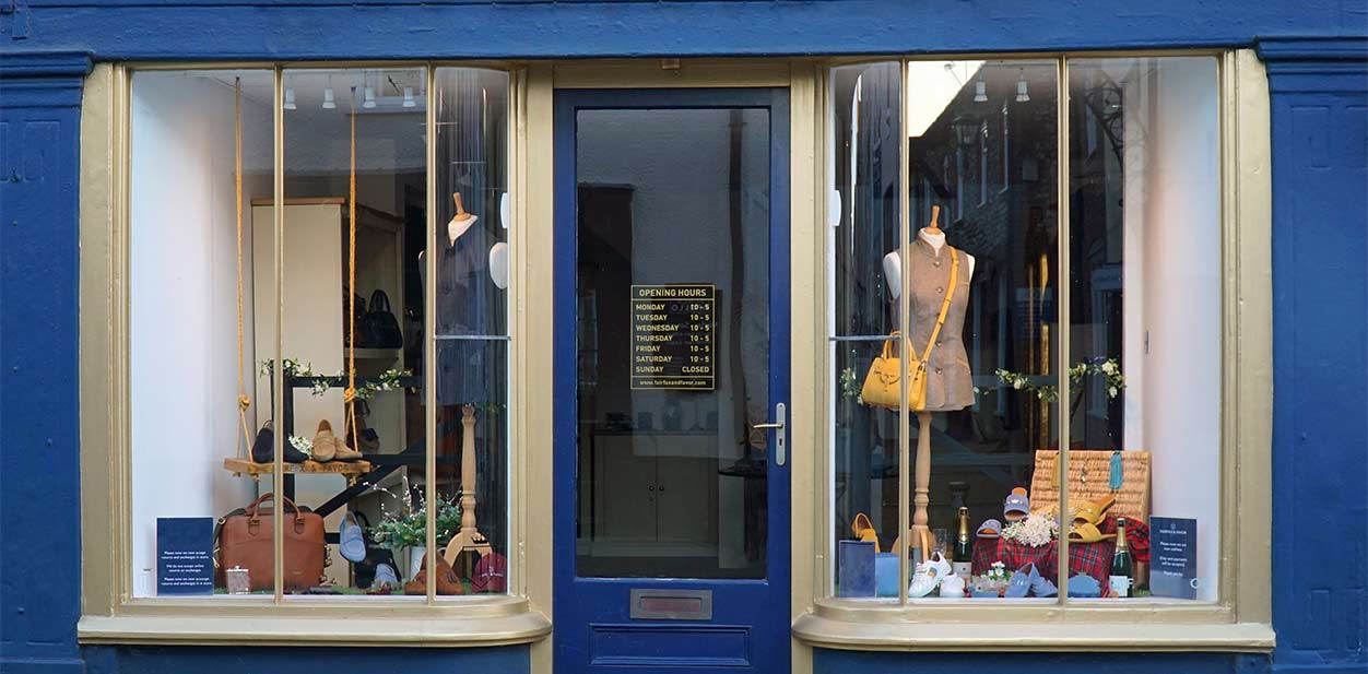 Retro retail store design with products displayed behind the storefront windows