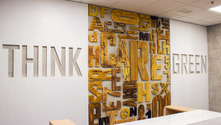 Think Green custom wall sign with engraved and cut-out letters and numbers made of wood