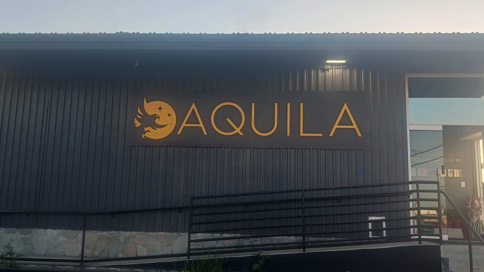 Aquila Transportation LLC outdoor sign mounted on the wall