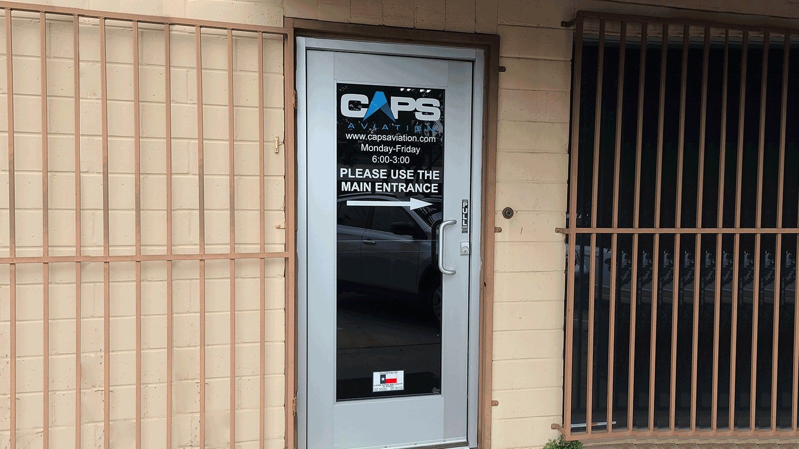 CAPS Aviation vinyl lettering attached to the door glass
