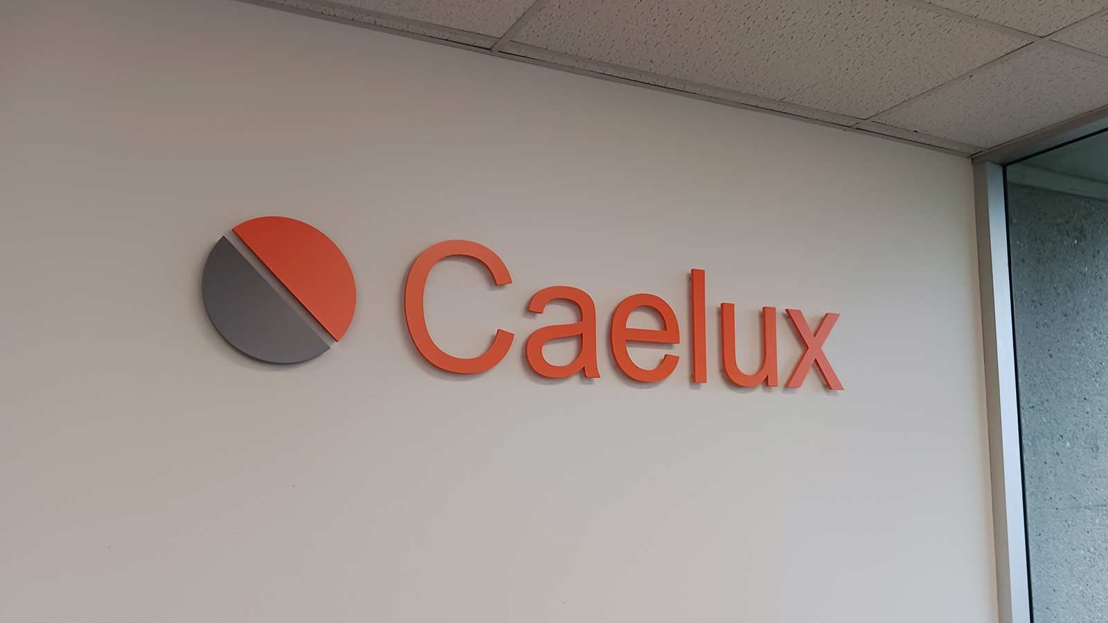 Caelux Corporation interior sign attached to the wall
