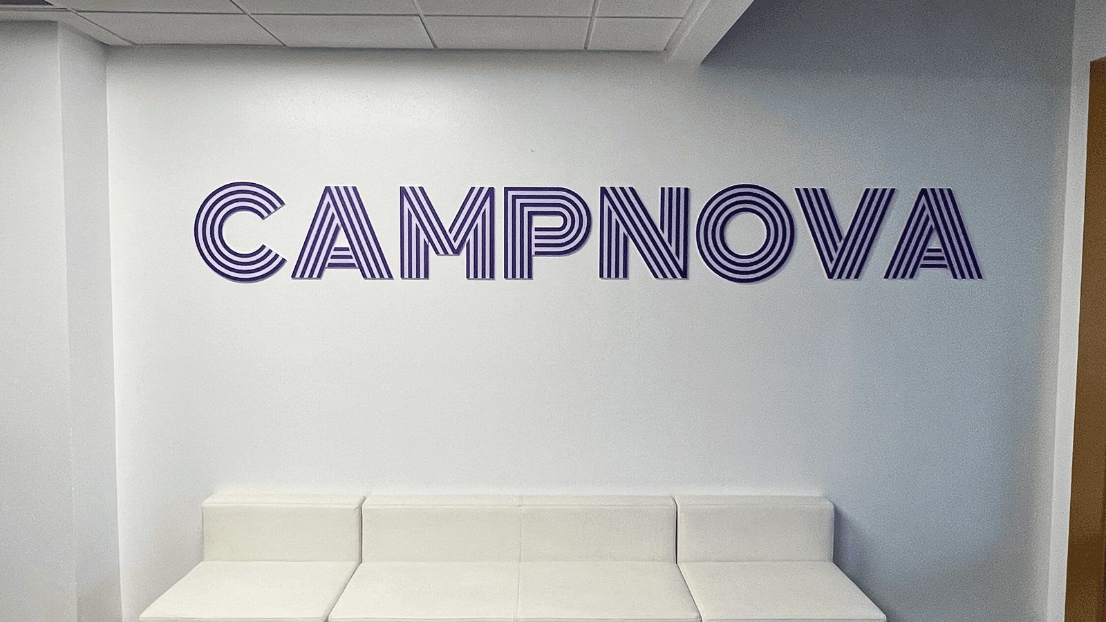 CampNova office sign mounted on the wall