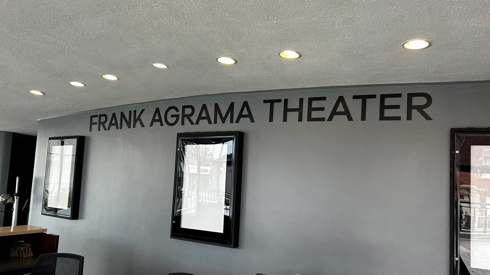 Frank Agrama Theater interior sign attached to the wall