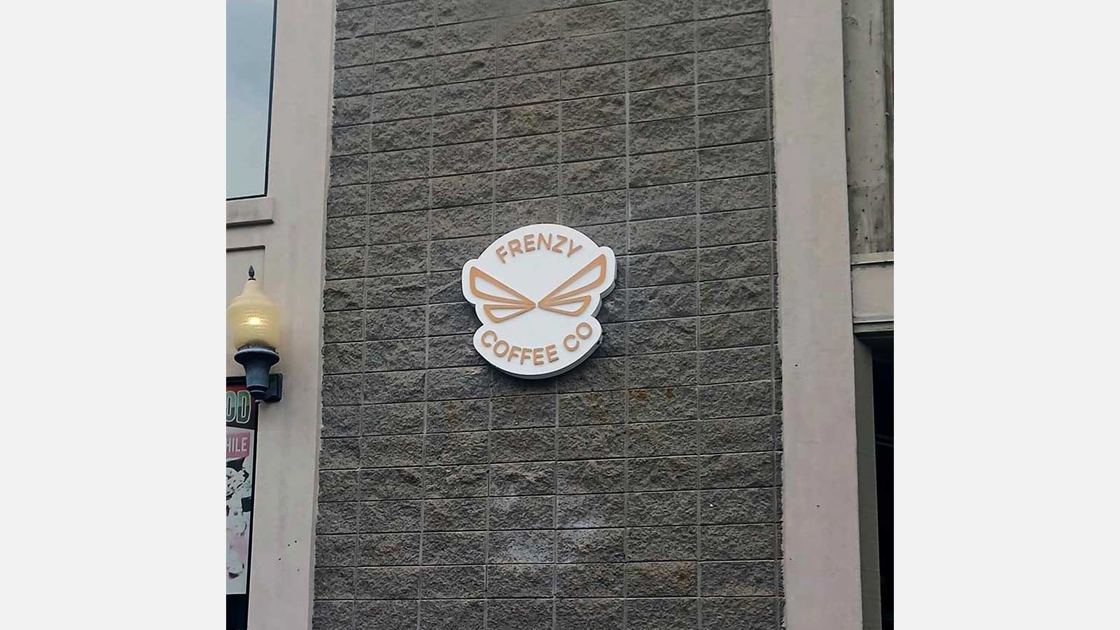 Frenzy Coffee Company push through sign on the wall