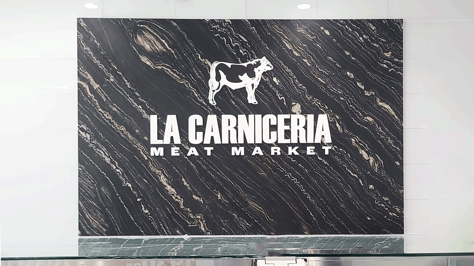 LA Carniceria Meat Market acrylic sign attached to the wall