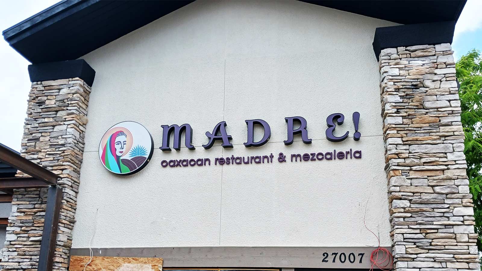 Madre restaurant signs mounted on the facade