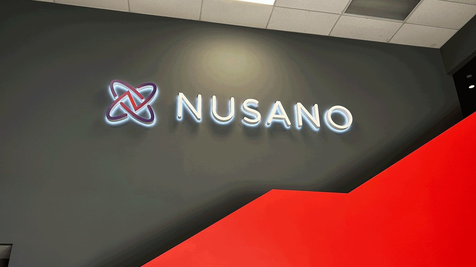 Nusano reverse channel letters attached to the wall