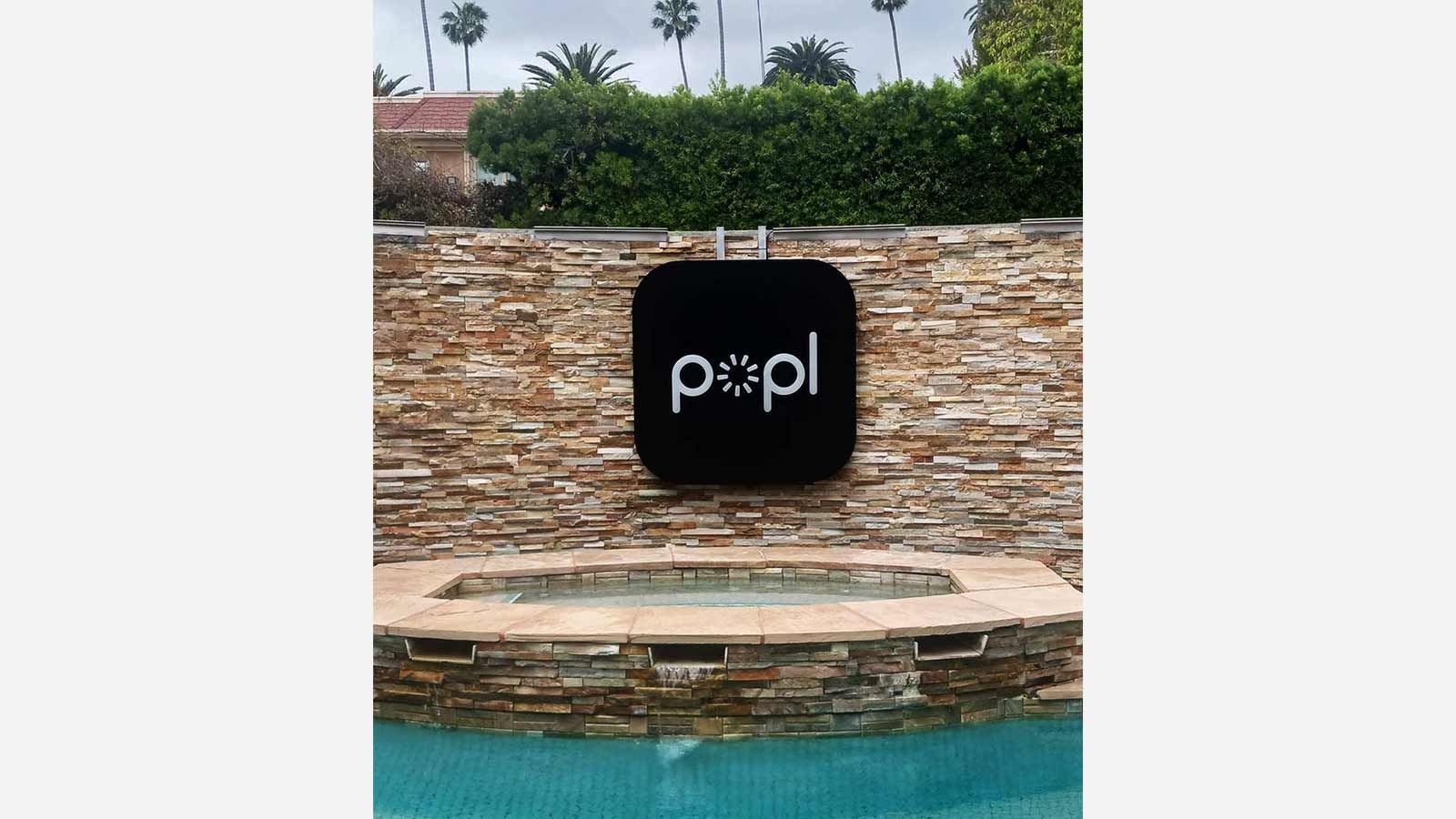 Popl light up sign mounted on the wall