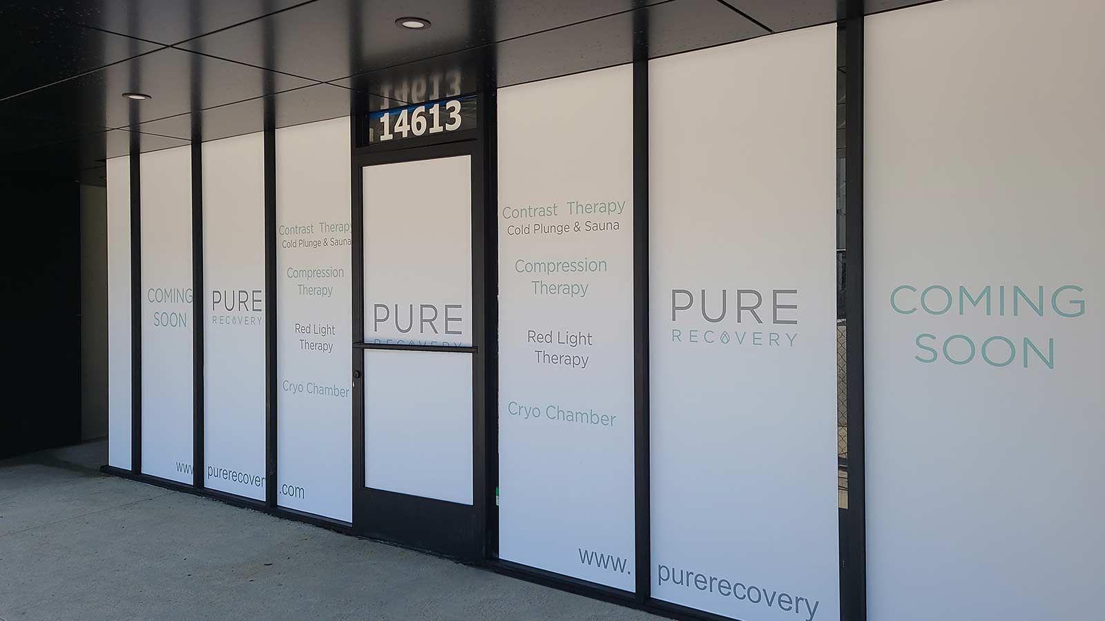 Pure Recovery window decals applied to the storefront