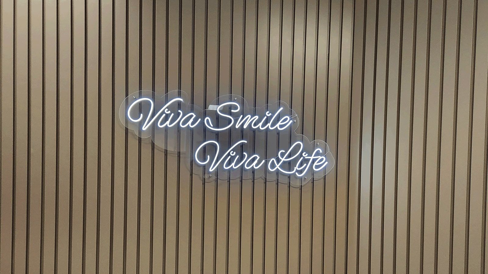 Viva Smile custom signage attached to the wall