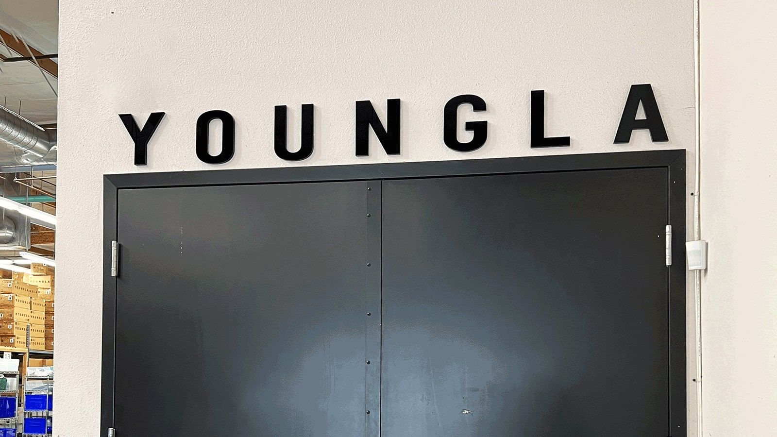 YoungLA acrylic sign attached to the wall