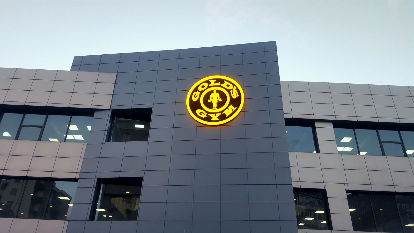 golds gym illuminated logo on building