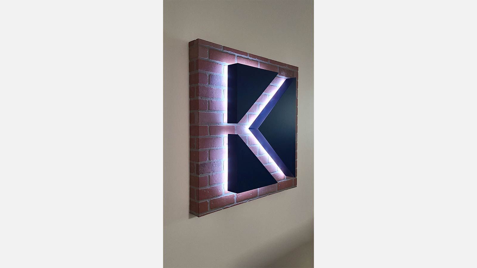 black k shaped indoor backlit logo