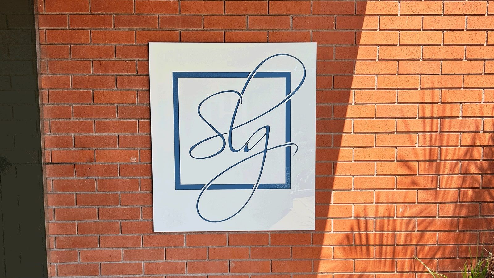 SLG Law firm wall signage installed outdoors