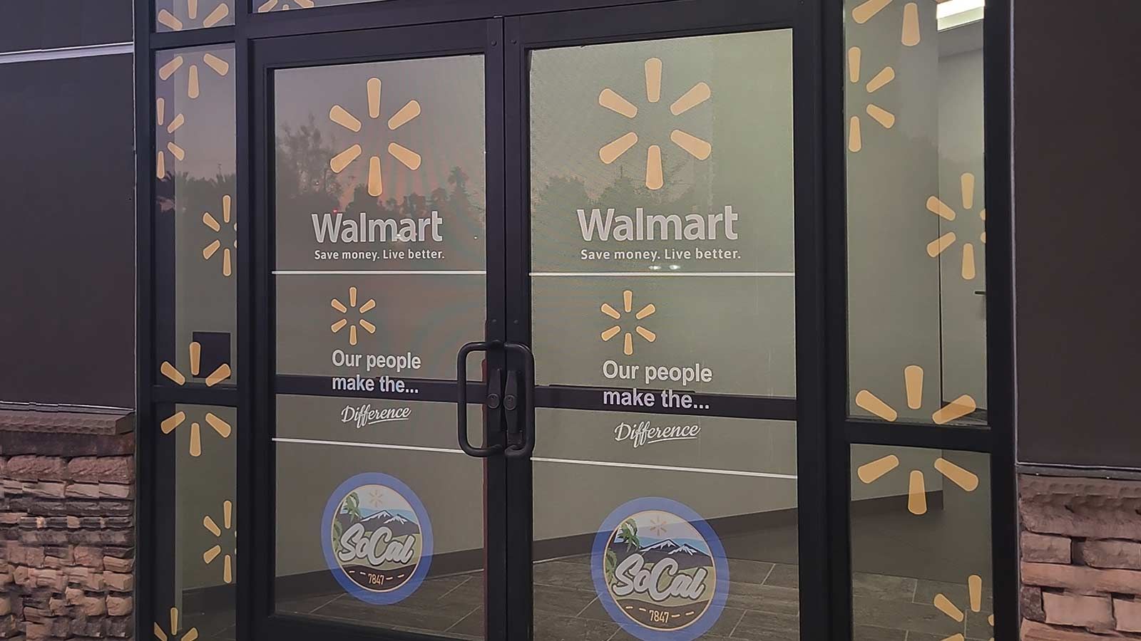Walmart store signs attached to the door glass