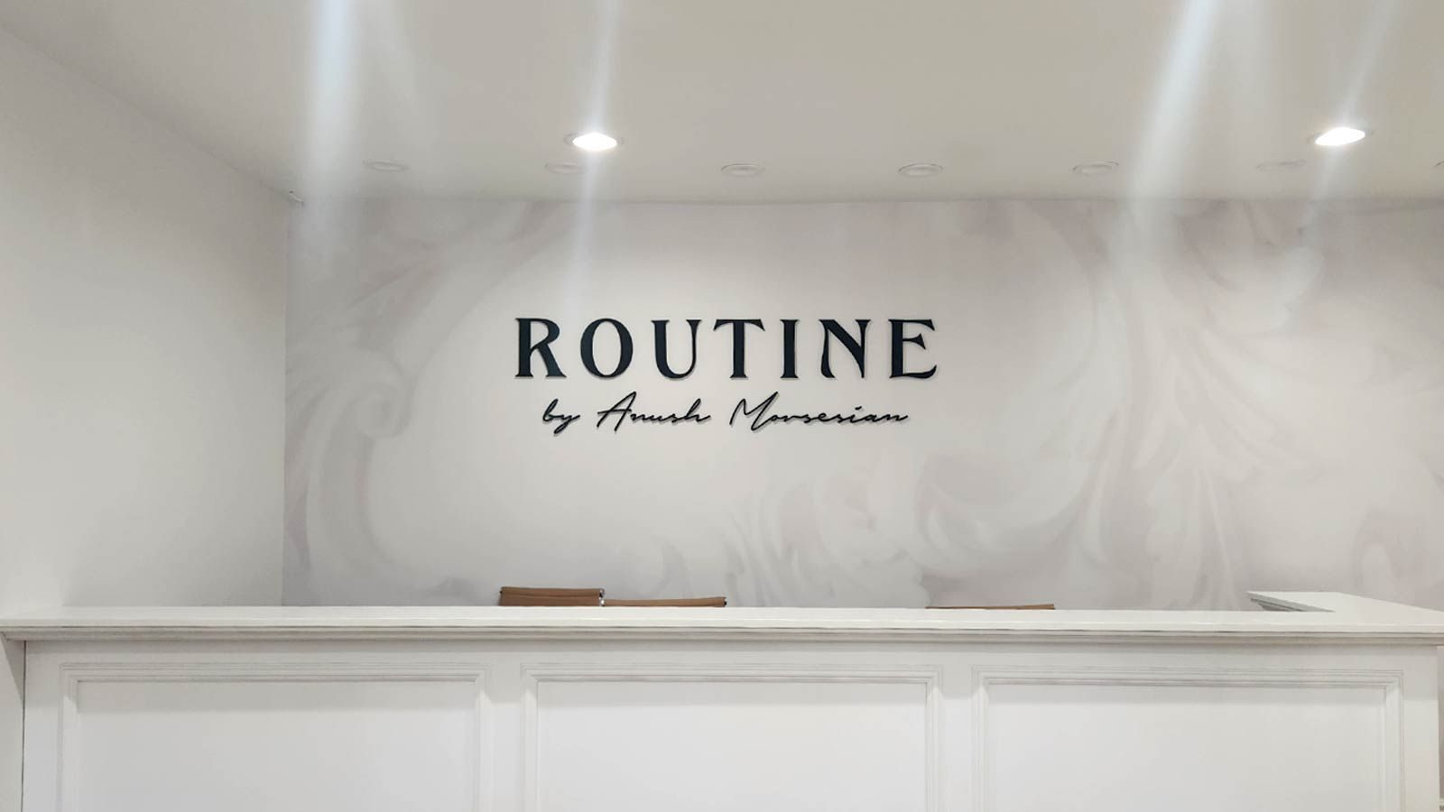 Routine by Anush Movsesian acrylic sign attached to a wall