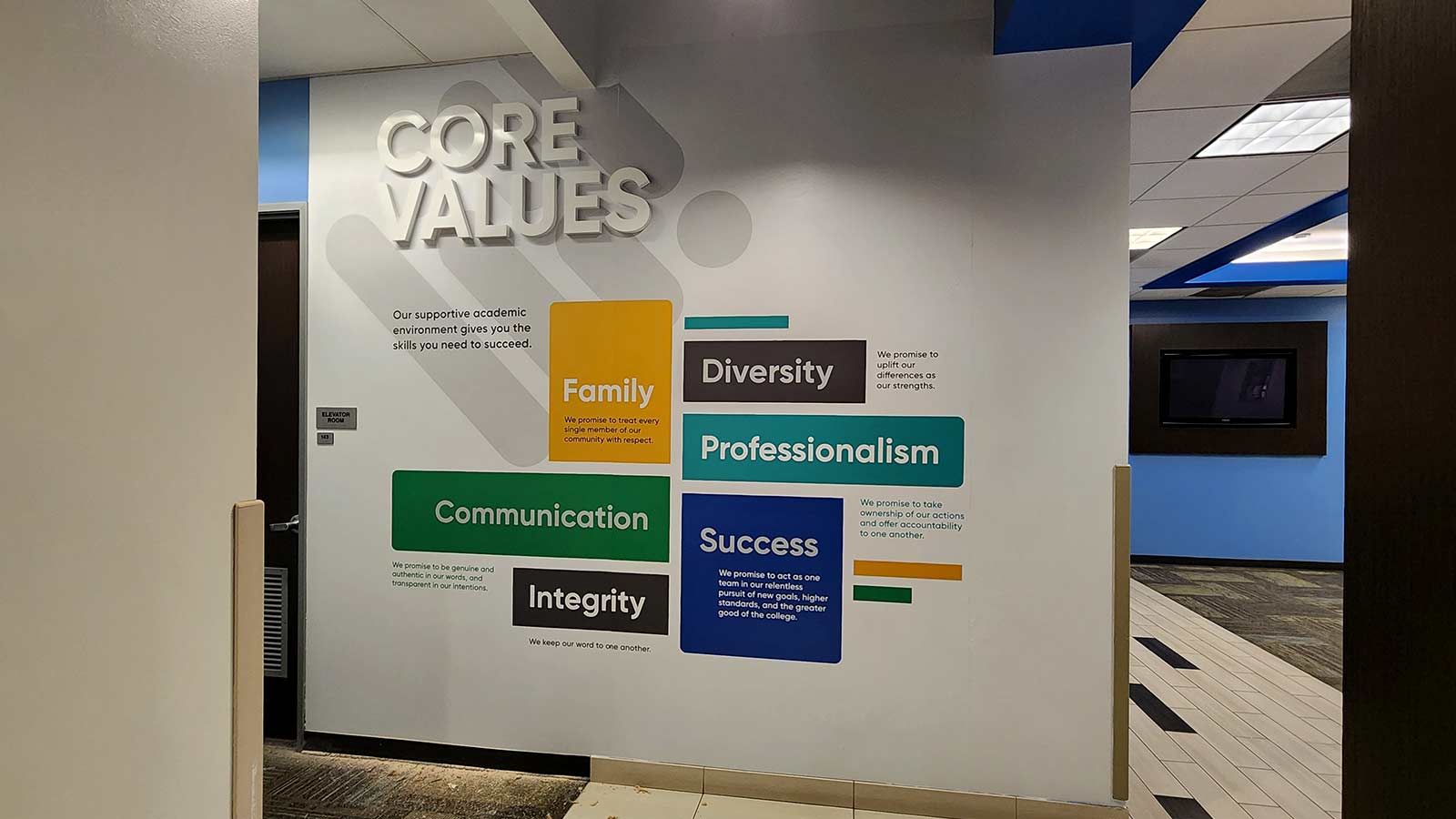 SJVC lobby signs displayed on the wall
