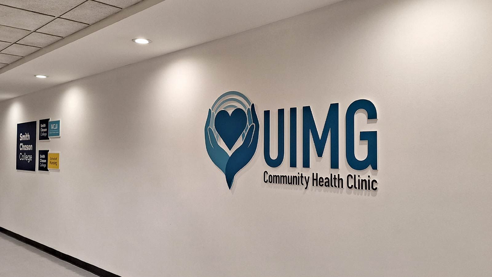 UIMG Community Health Clinic foam core sign on a wall