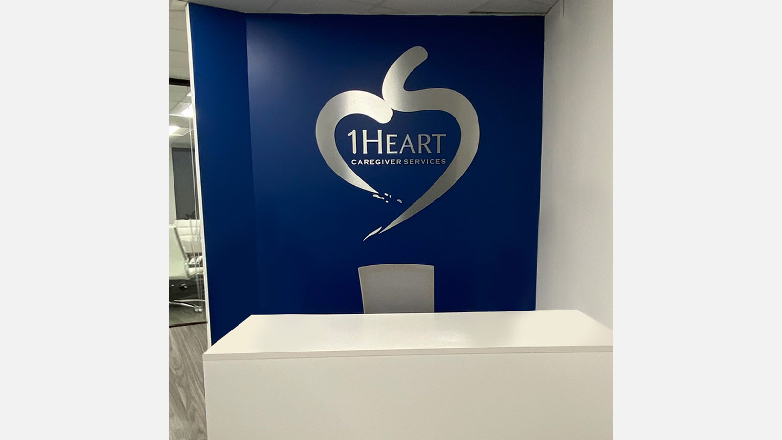1Heart Caregiver Services lobby sign set up in the office