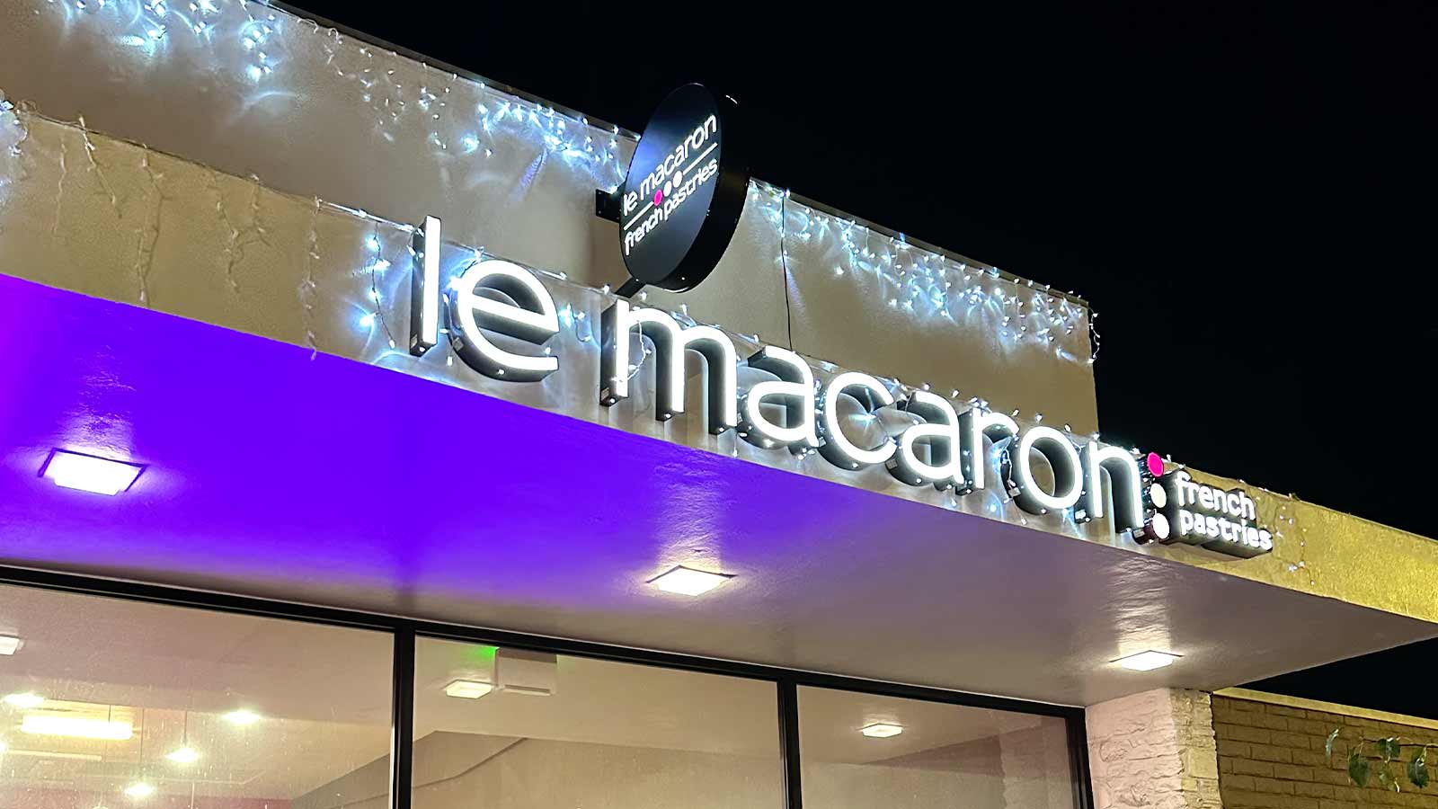 Le Macaron store signs attached to the storefront