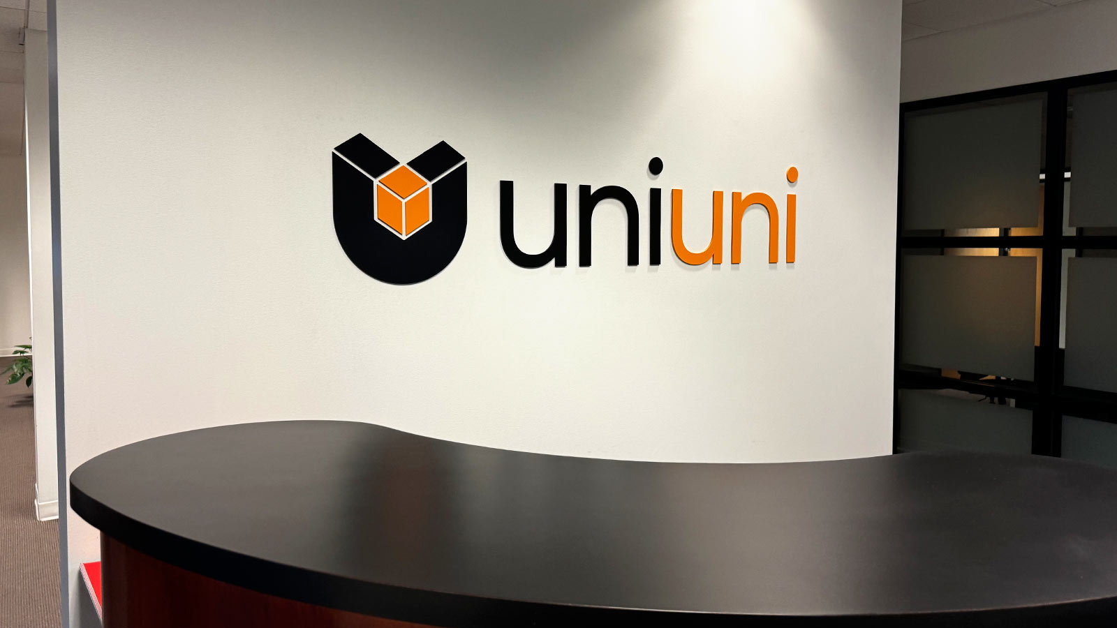 Uni Express Inc office sign installed on the lobby wall