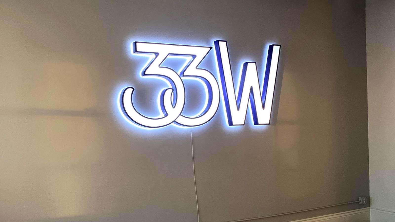 33 and west backlit interior sign installed on the wall
