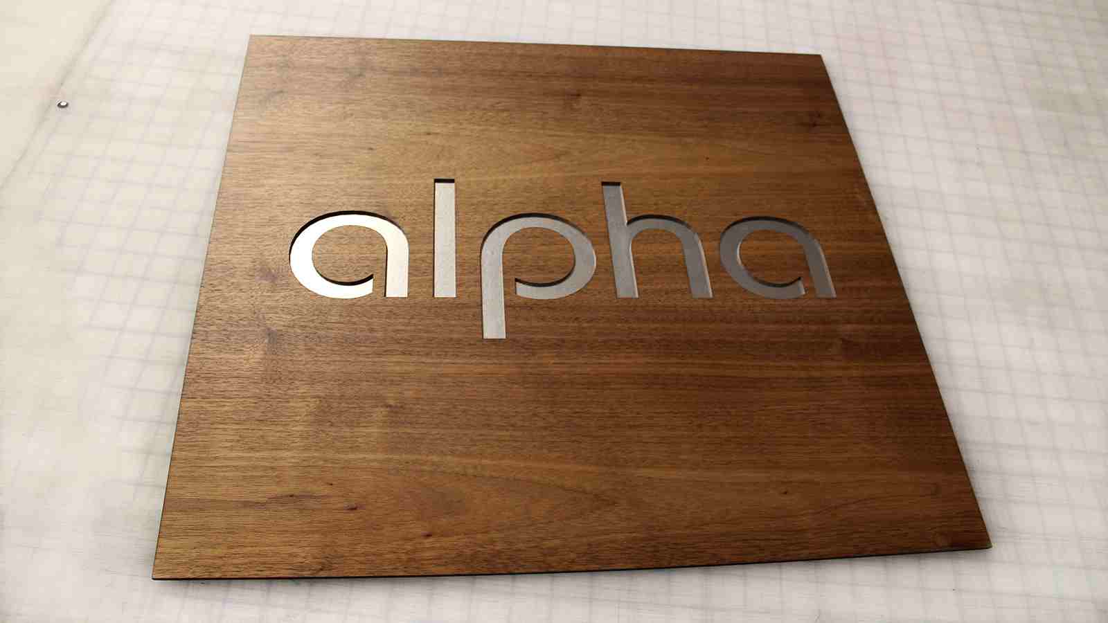alpha wooden sign with aluminum letters