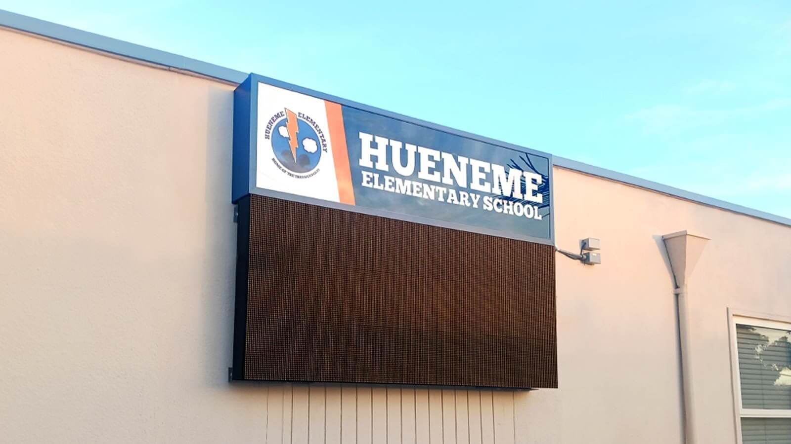 hueneme outdoor sign installed on building