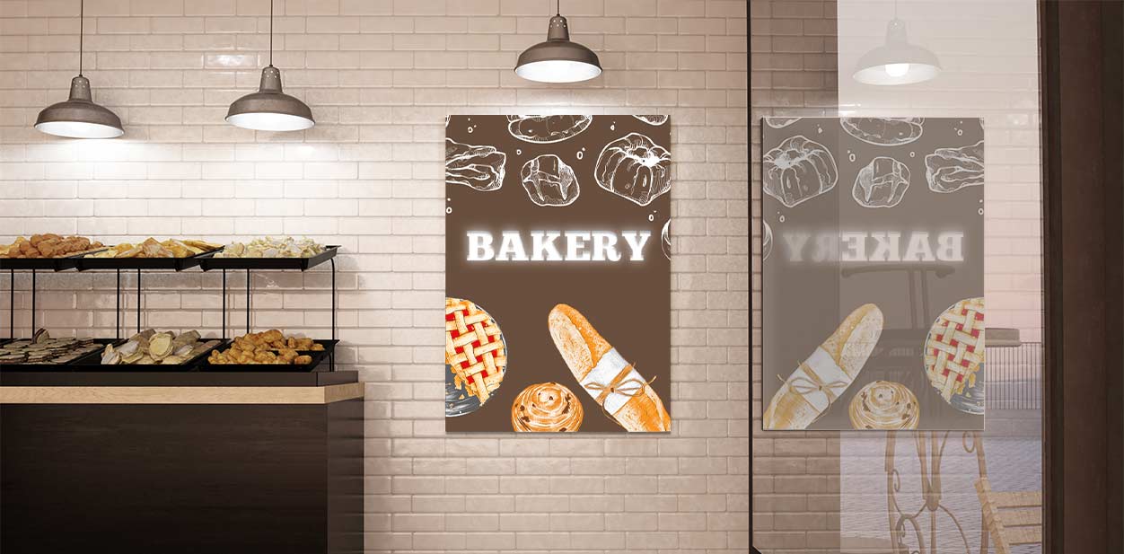 Illuminated wall art for bakery showcasing artisanal dough creations and the word bakery.