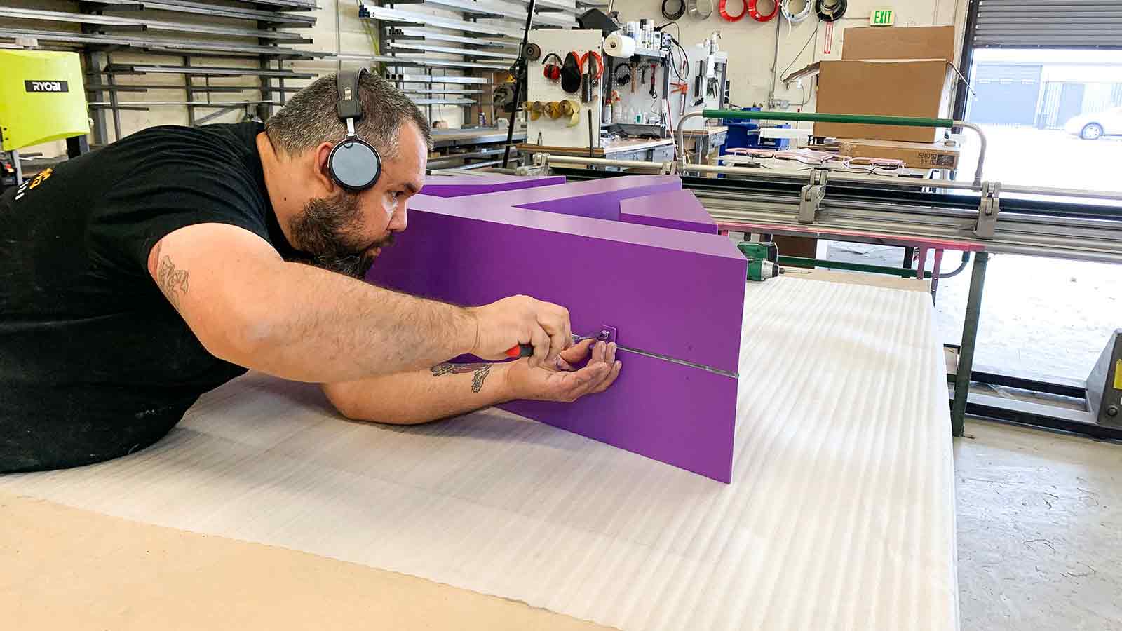 purple painted 3d structure sign making