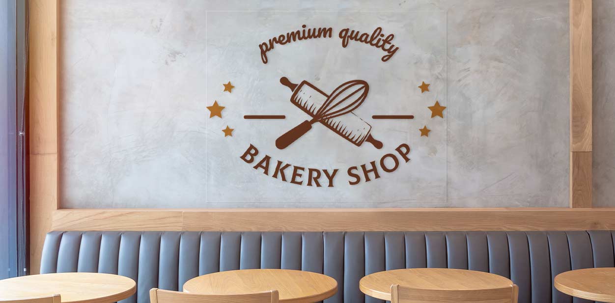 Transparent bakery wall art with utensils showing the text premium quality bakery shop.