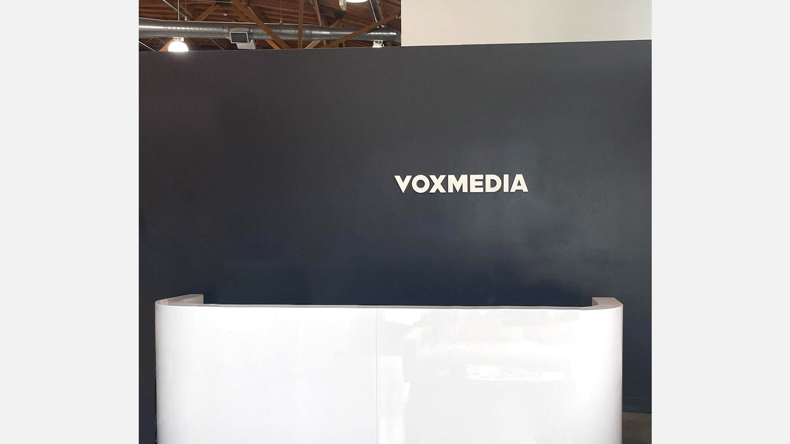 vox media lobby sign installed on the wall