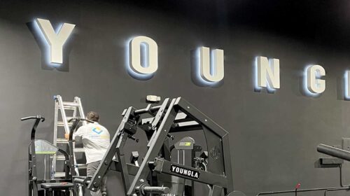 youngla gym sign installation on the wall
