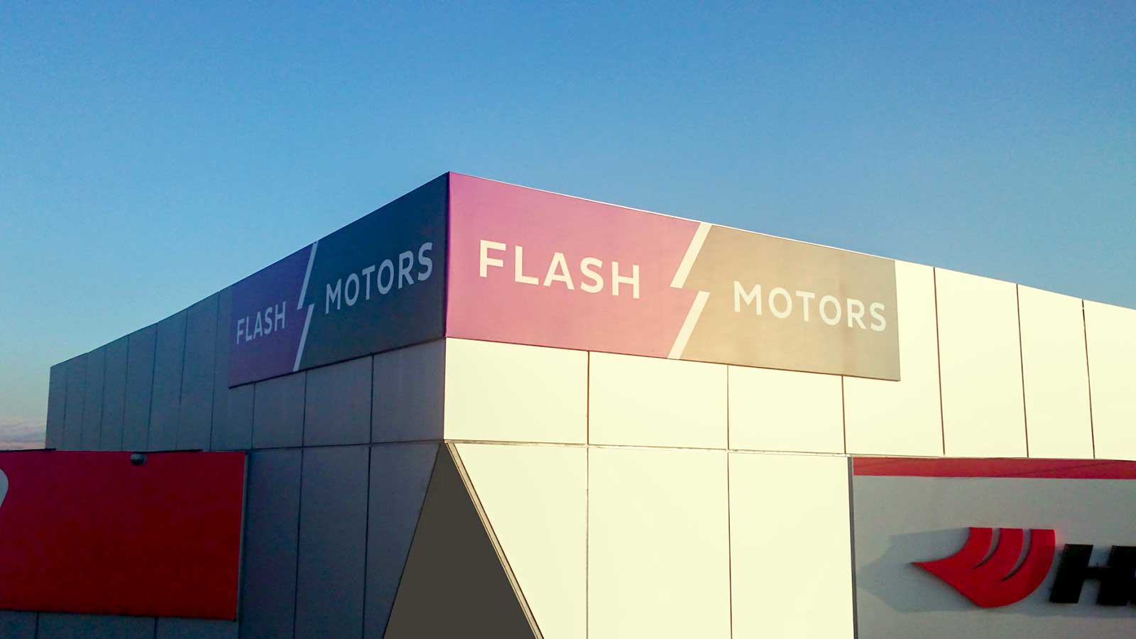 flash motors aluminum signs on building