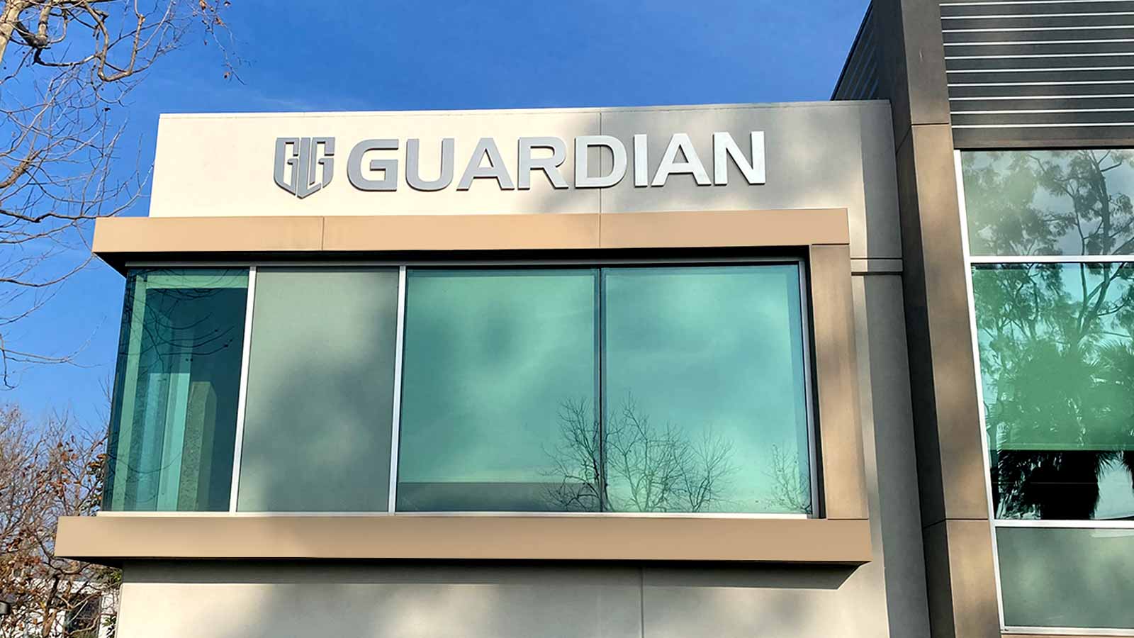 guardian litigation group building sign mounted on a facade