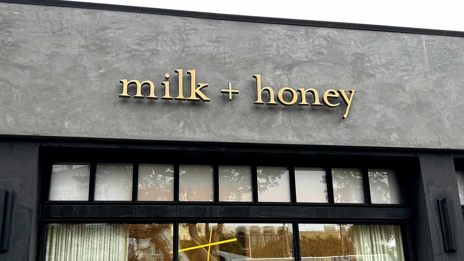 milk honey brentwood backlit letter installation on a facade