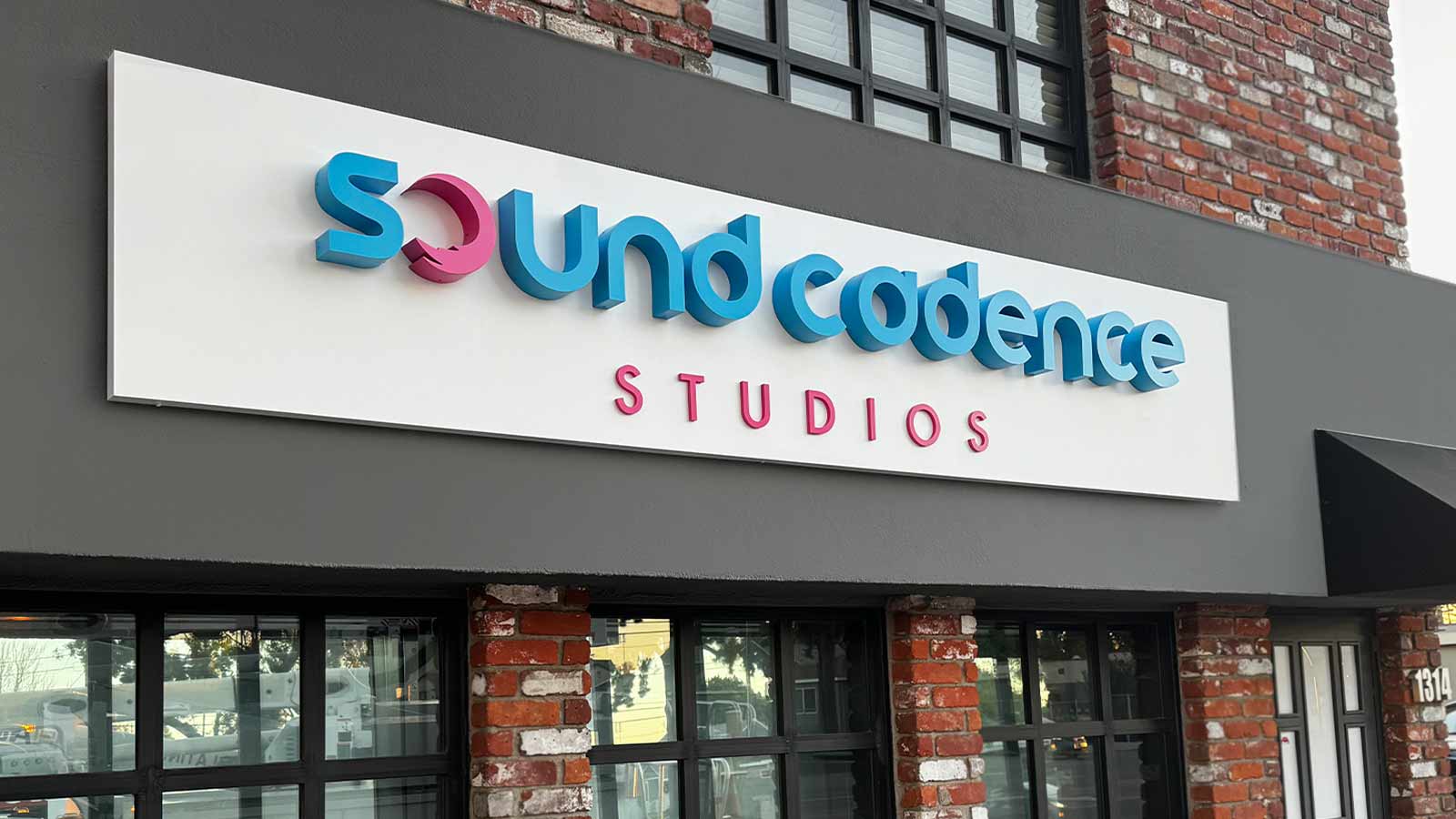 sound cadence studios outdoor sign mounted on the facade