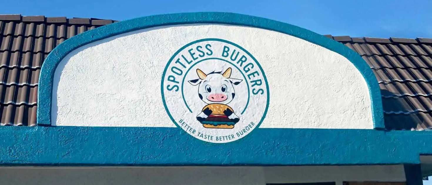 Spotless Burgers hand painted murals crafted on an exterior wall for branding