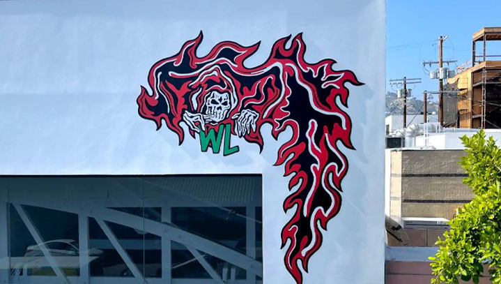 Warren Lotas painted murals colored in black, white, red and green for exterior wall decor