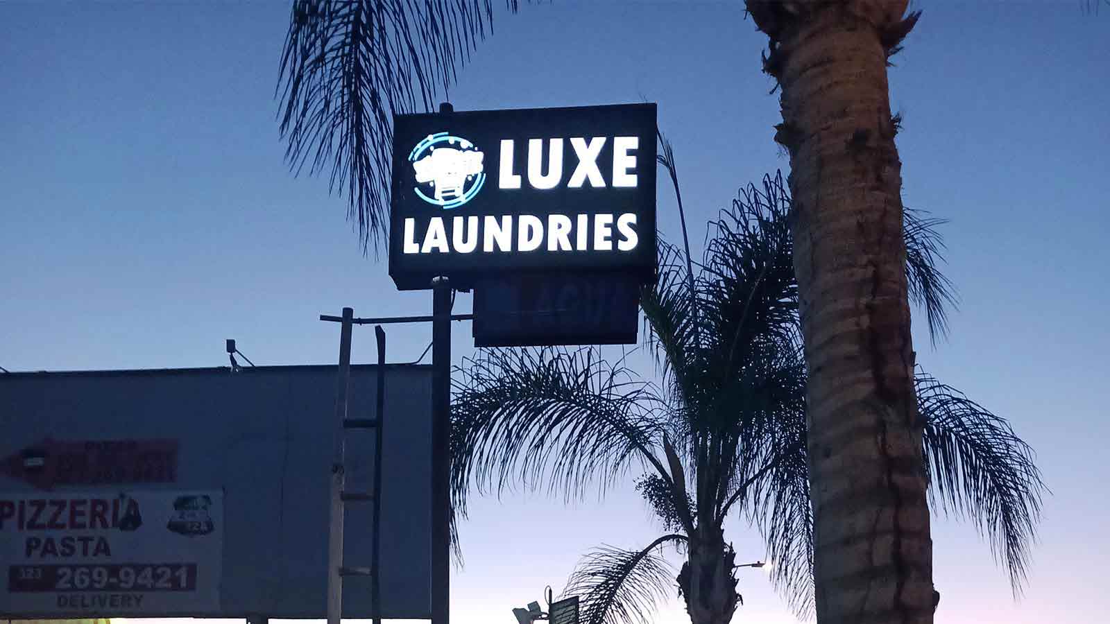 luxe laundries illuminated promotional pylon sign
