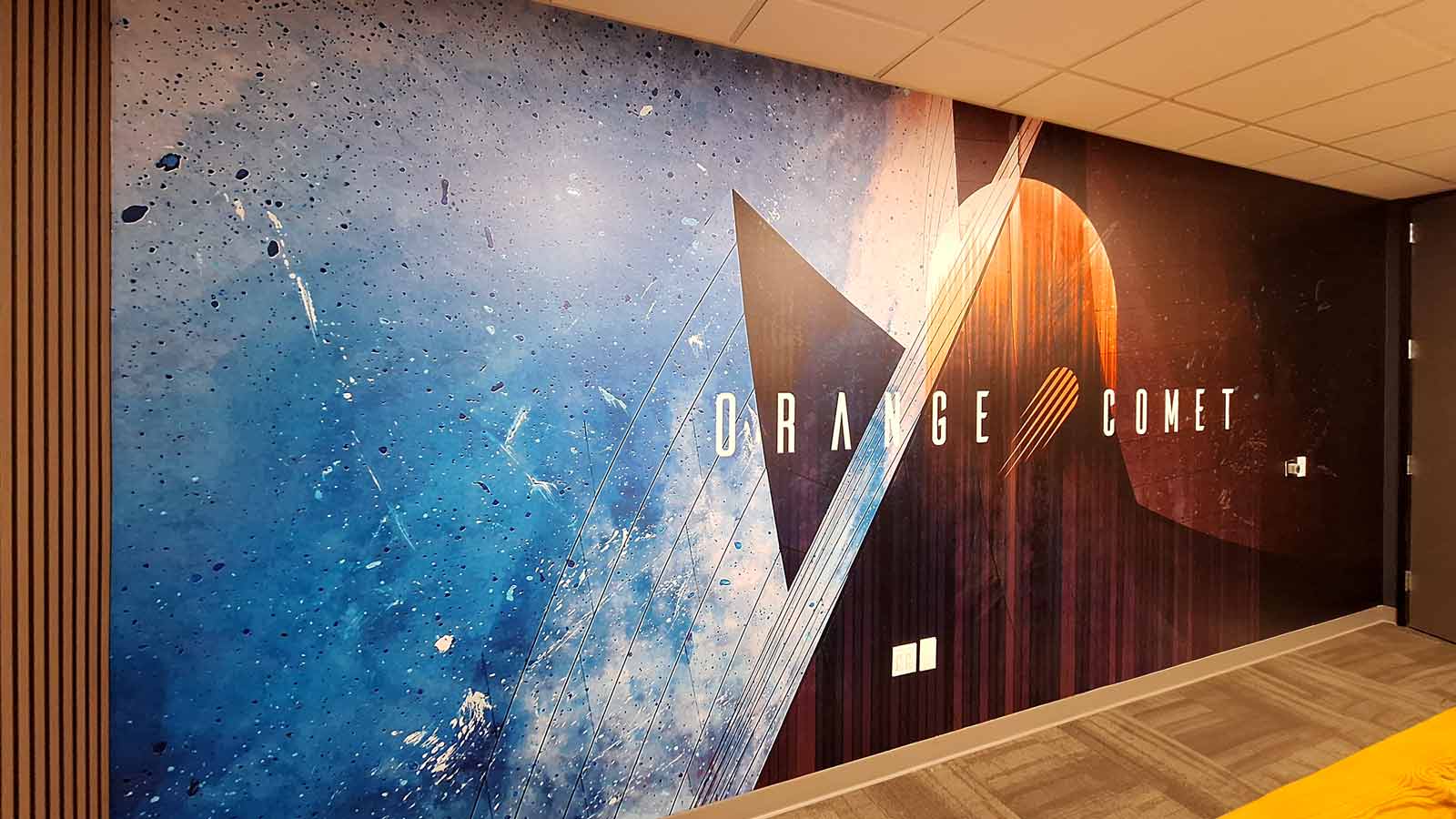 orange comet office sign installed on the wall