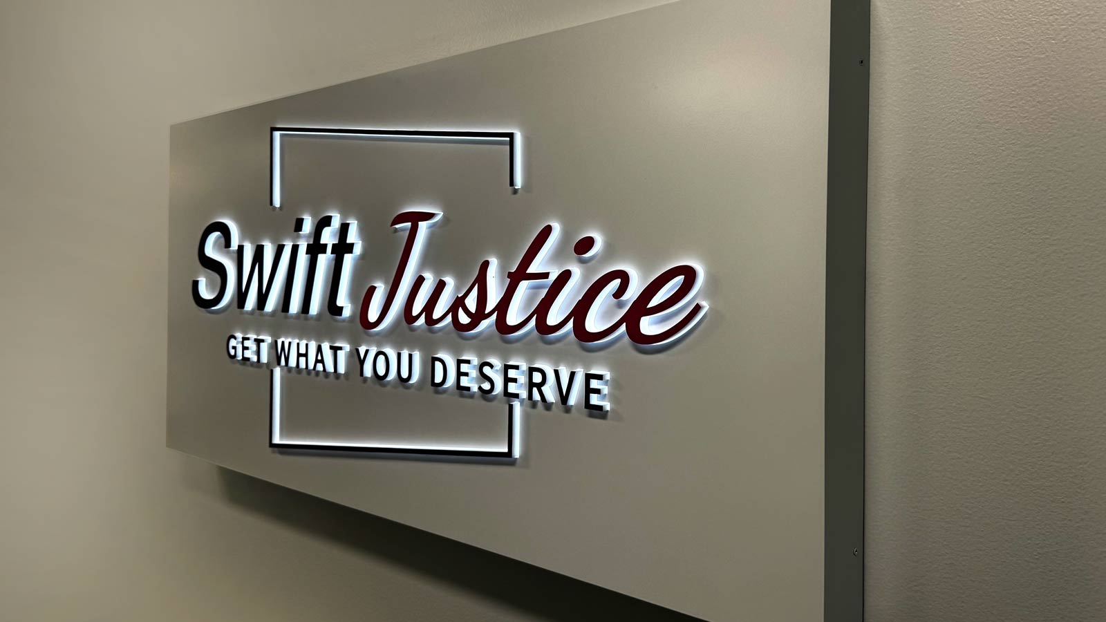swift justice inc push through sign mounted on the wall