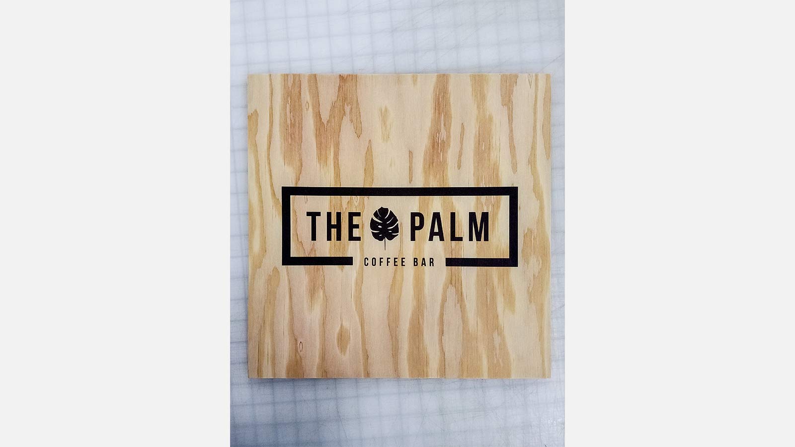 the palm printed wooden signage