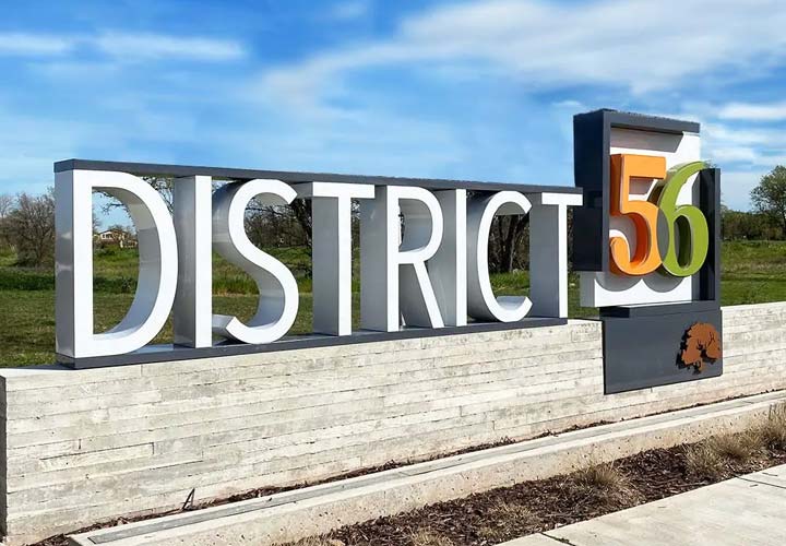 Bold outdoor freestanding sign for District 56 with a concrete base.