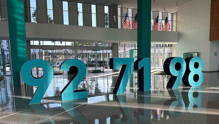 Freestanding foam board sign featuring the large numbers 92, 71, and 98.
