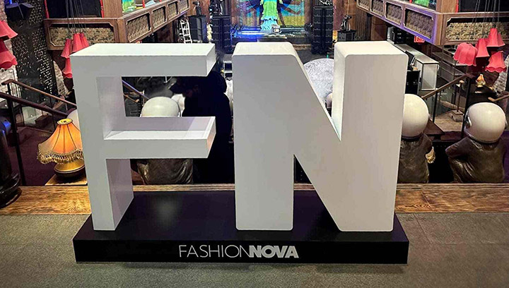 White freestanding sign for the Fashion Nova corporate event, installed indoors.