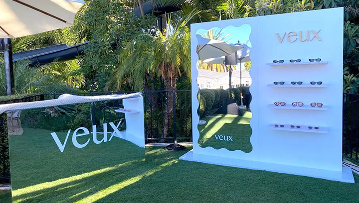 White Veux sunglasses trade show freestanding signs with a mirror, bar, and products.