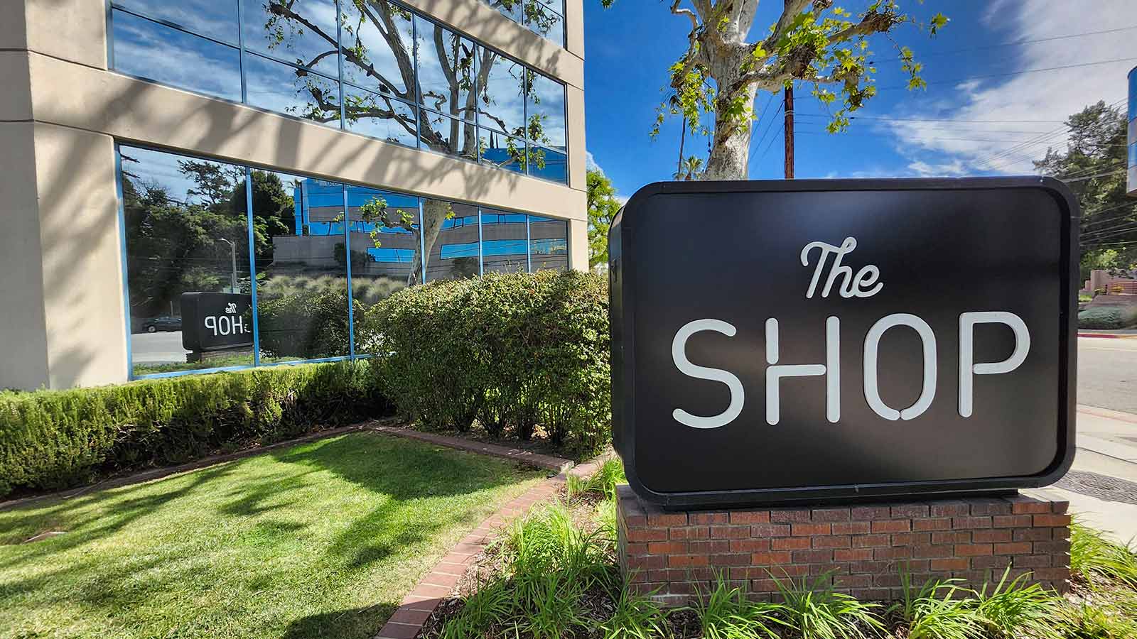 The Shop monument sign face replaced on street base